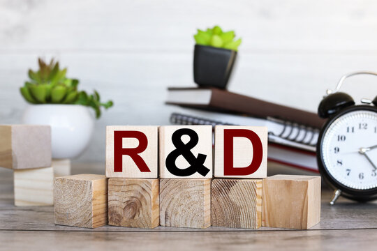 R and D word written on wooden blocks. Sales, business concept