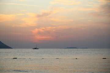 Beautiful sunset over the calm sea with cloud sky background.