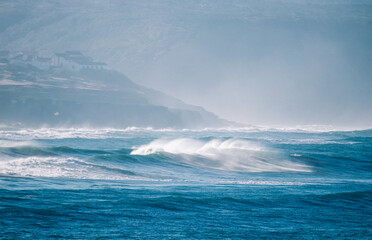 Big breaking Ocean waves hit the coastline. Strong wave