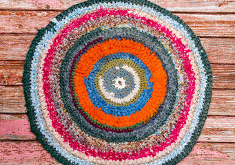 Colorful vintage handicraft rug made from strips of cloth as background
