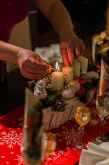Fototapeta na wymiar detail of a woman lighting an advent candle