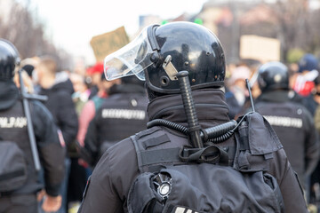 Police force on duty during crowd protest or demonstration - obrazy, fototapety, plakaty