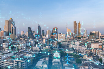 Fototapeta na wymiar Glowing hologram of technological process, aerial panoramic cityscape of Bangkok at sunset. The largest innovative hub of tech services in Southeast Asia. Multi exposure.