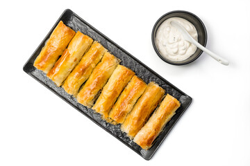 Meat rolls pastry - fried minced pork meat in spring rolls in a serving plate with a bowl of tartar 

sauce, isolated on white background with clipping path included. Top View