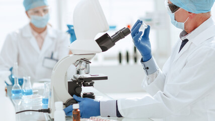 close up. ambitious scientist sitting at a laboratory table .