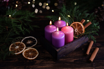Christmas eve, four purple burning advent candles.