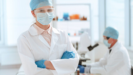 close up. doctor in a protective mask standing in the laboratory.