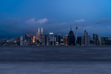 Obraz premium Panoramic Kuala Lumpur skyline view, concrete observatory deck on rooftop, night. Asian corporate and residential lifestyle. Financial city downtown, real estate. Product display mockup empty roof