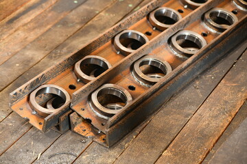 The rings welded by welding on the channel, the prefabricated metal structure lies on a wooden rack.