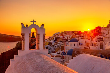 Fototapeta premium Beautiful sunset with famous Orthodox church on Santorini island, Aegean sea, Greece.