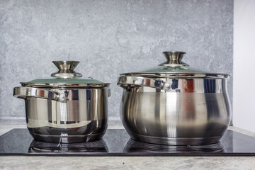 two pots are on an electric or induction hob
