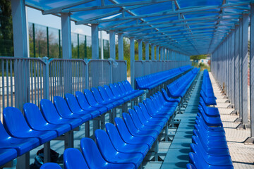 Rows of empty blue plastic seats