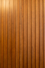 Decorative wall made of wood with wooden slats. Creative vintage background.