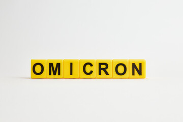 The word omicron consists of individual cubes with letters. A new strain of coronavirus omicron.
