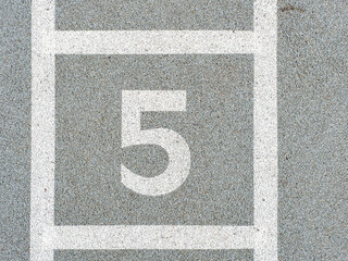 Number five painted on soft rubber surface. The fifth possition
