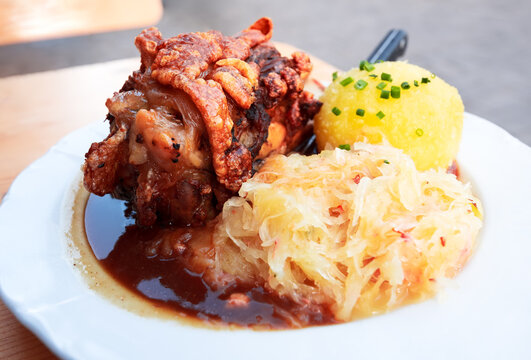 Schweinshaxe, German cuisine with pork knuckle, cabbage and pota