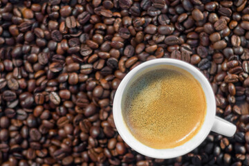 A cup of espresso with a coffee bean background