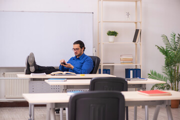 Young male teacher in front of whiteboard