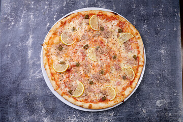 fish pizza on the dark background