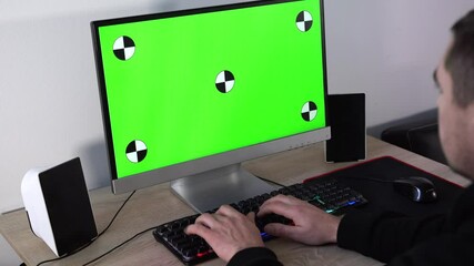 office worker typing on keyboard and looking at green screen - Powered by Adobe