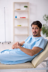 Fototapeta premium Young male patient waiting for doctor at the hospital