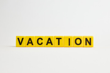 The word vacation consists of individual cubes with letters.