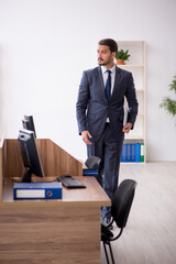 Fototapeta premium Young male employee working in the office