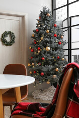 Decorated Christmas tree in light dinning room