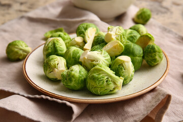 Plate with fresh Brussels cabbage on table, closeup