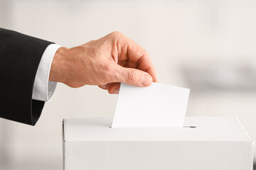 Voting man near ballot box