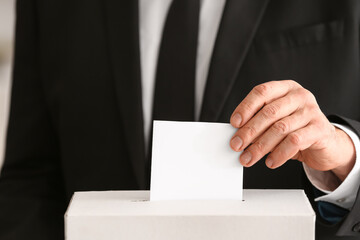 Voting man near ballot box, closeup view