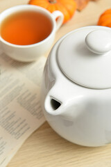Fototapeta na wymiar Tea pot on wooden background, closeup