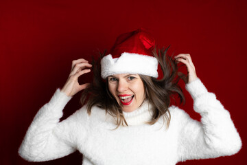 Christmas - happy smiling young woman in Santa helper hat is dancing