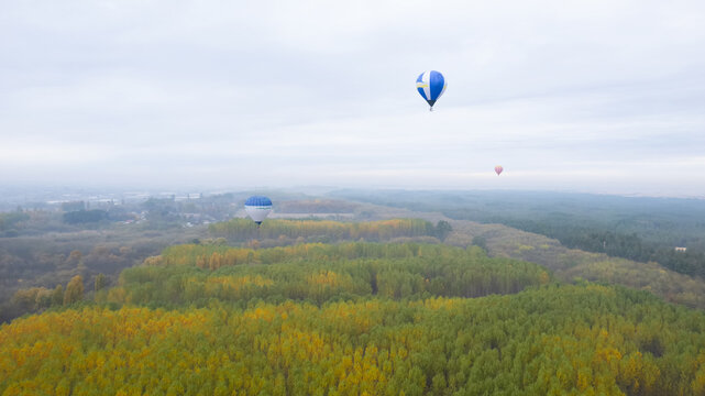 Hot air baloon over the colorful autumn trees. Concept for fall background. Artistic picture. Great idea for travel