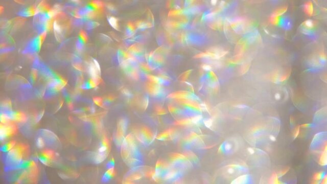 Abstract shiny glitter 4k video background Golden and pearl glitter background with sparkling texture White shimmering light, sequins sparks, and glittering glow foil background.