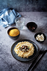 Corn porridge with fried bacon, parsley and Feta cheese in a bowl