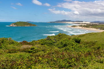 Trail to the beach with vegetation, rocks and mountain
