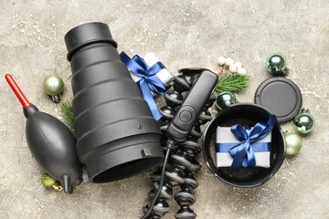 Modern equipment of photographer and Christmas decor on grey background