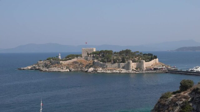 Kusadasi, Turkey - August 23, 2021: Pigeon Island Castle, (Guvercinada kalesi in Turkish) is a tourist attraction.