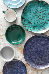 Set of stylish dinnerware on light grunge background