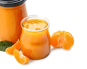Jars of tasty tangerine jam on white background, closeup