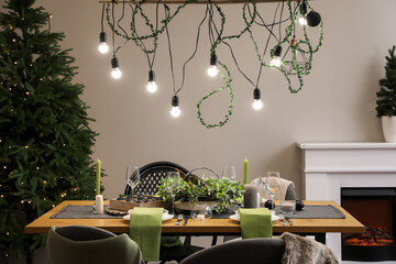 Dining table with beautiful setting for Christmas celebration in festive room