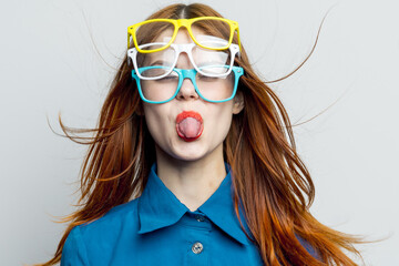 woman with multicolored glasses on her face in blue shirt posing glamor