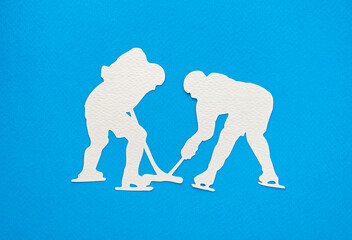 Paper craft hockey players on blue background