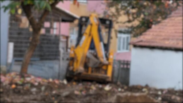 mini excavator, mini excavator coming to construction site, blur effect