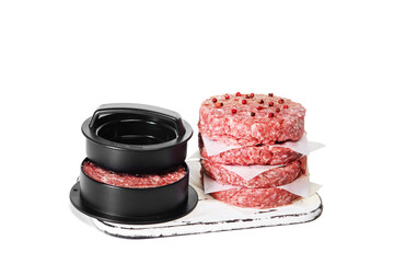 Raw hamburger meat isolated on wooden board on white background