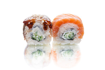 Two pieces of Japanese inside out sushi roll with unagi eel and cream cheese inside. cheese, sesame...