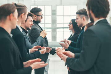 close up. two business teams applauding their leaders