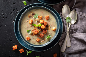 Vegan mushrooms soup with champignons, herbs and cream.