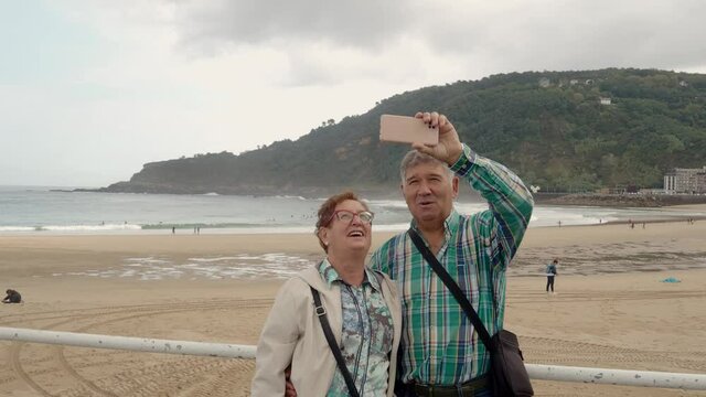 Spanish retired couple taking a selfie in the city of San Sebastian
